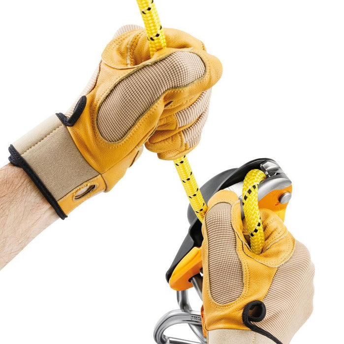 Professional wearing gloves showing the cam can be manipulated to feed out slack easily or belay a lead using climbing techniques.