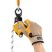 Hand model wearing a glove showing he rope can be installed with the Petzl Spin L2 Double Pulley connected to the anchor.