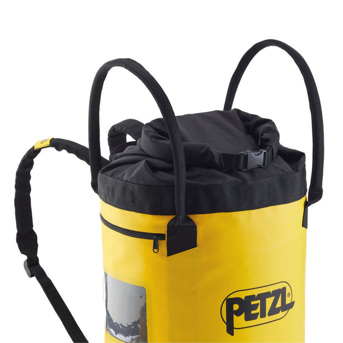 Yellow Petzl 45 Litre Rope Bag highlighting the two large handles, which allow the bag to be carried by hand and can also haul up to 50 kg.