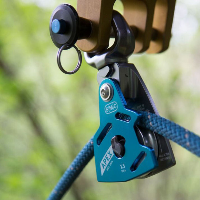 Apex Swivel Pulley rigged on a system with a rope, showcasing its secure and functional setup in an outdoor environment.

