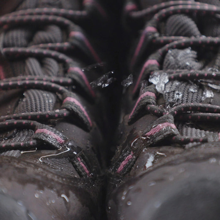 Close up of black nubuck shoes with black and purple laces demonstration of Waterproofing with Gear Aid Tent Water Rellent 