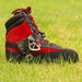 Red and black climbing boot fitted with the ISC Stryder Left Foot Ascender, demonstrating secure attachment and functionality for rope climbing applications