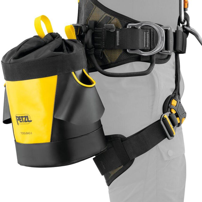 Professional wearing a harness with the Petzl Toolbag 6 pouch attached to the harness,  providing quick access to equipment.