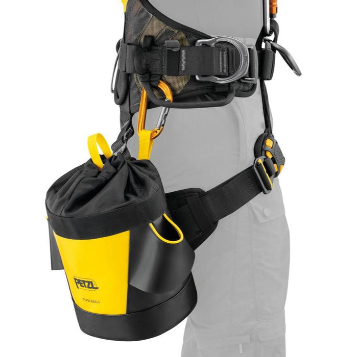 Professional demonstrating Petzl Toolbag 6  pouch attached to a harness with a classic
carabiner.