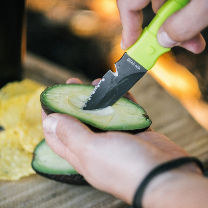 Hand model demonstrating Green Gear Aid Akua River Knife Slicing an Avacodo 