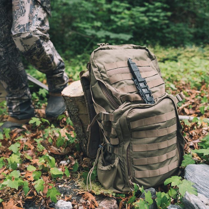 Black Gear Aid Kotu Knife mounted on the front of a coyote coloured gear bag