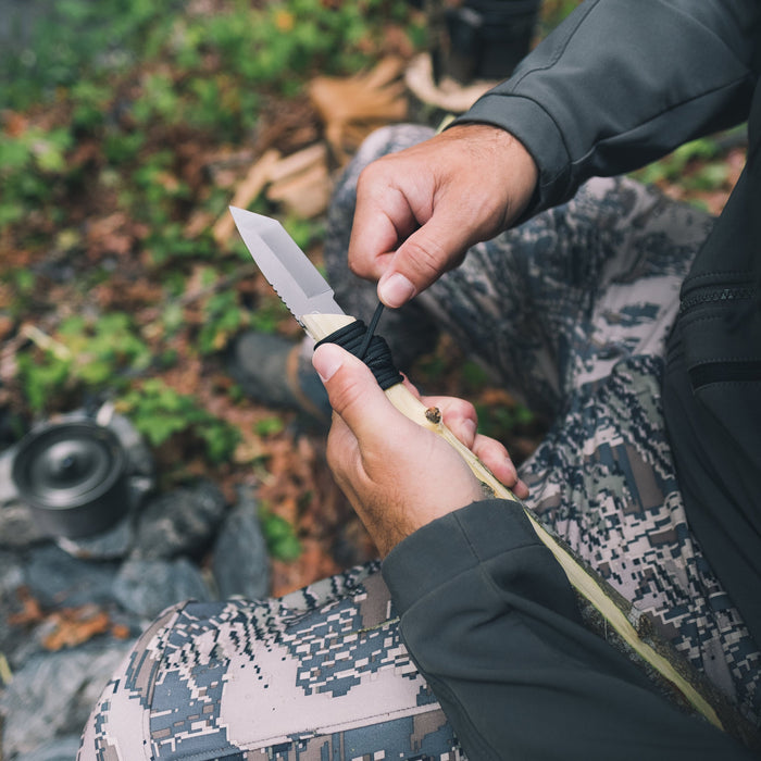 Gear Aid Kotu Black Knife in use outdoors and being attached to a stick 