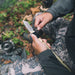 Gear Aid Kotu Black Knife in use outdoors and being attached to a stick 